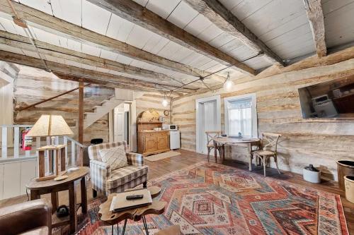 a living room with a couch and a table at Rustic Augusta Cabin in Augusta