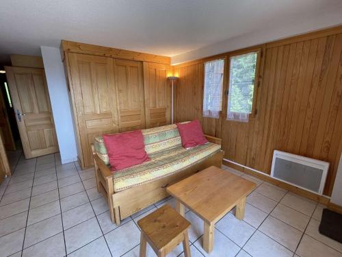 Cette chambre comprend un canapé et une table. dans l'établissement Appartement 3 pièces, Les Saisies, ski-in, 9 pers, balcon sud - FR-1-810-18, aux Saisies