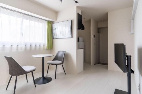 a living room with a table and two chairs at Laurea Tower Ikebukuro in Tokyo