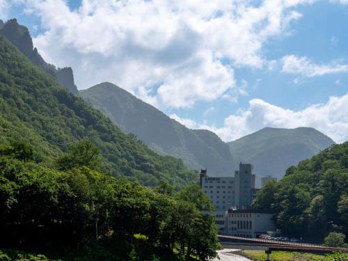a view of a valley with mountains in the background at 層雲閣 in Kamikawa