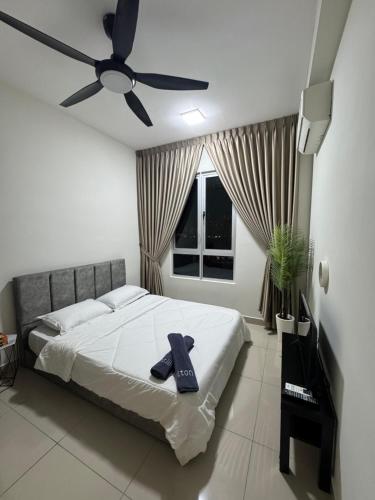 a bedroom with a bed and a ceiling fan at Studio Stay in Kuala Lumpur