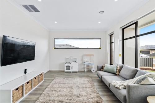 a living room with a couch and a flat screen tv at Yarrawonga Getaway in Yarrawonga