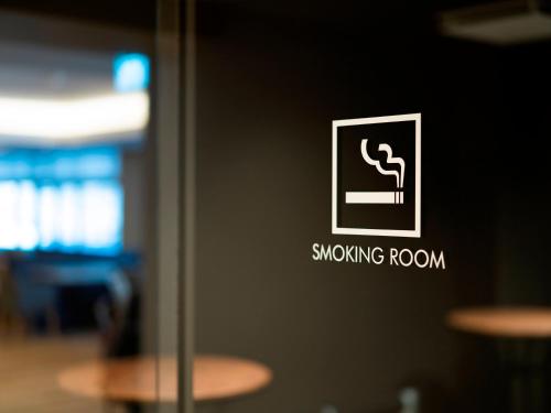 a close up of a smoking room sign on a wall at 層雲閣 in Kamikawa