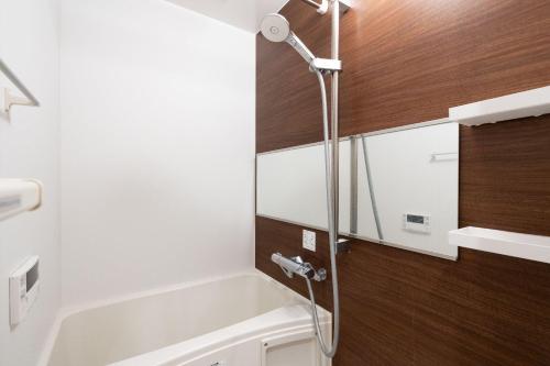 a bathroom with a bath tub and a shower at Laurea Tower Ikebukuro in Tokyo