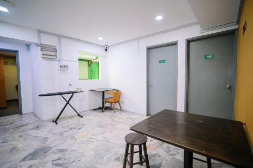 a meeting room with two tables and two chairs at Swing & Pillows - Seri Kembangan Selangor in Seri Kembangan