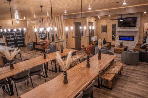 a large room with long wooden tables and chairs at Luxury 12-Bedroom Cabin with Indoor Pool, Hot tub & Movie Theater, Sleeps 36 in Sevierville