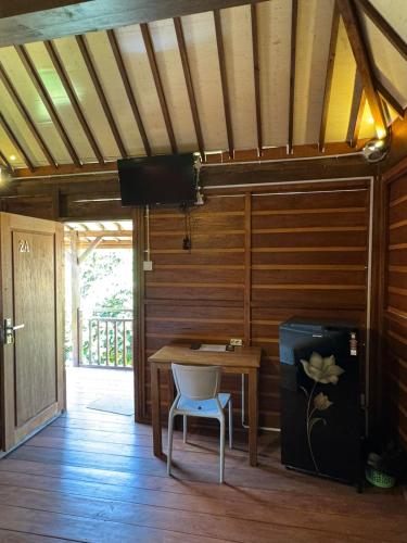 a wooden room with a table and a chair at Pecatu home stay in Uluwatu