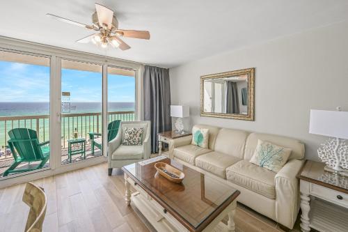 a living room with a couch and a view of the ocean at Pelican Beach Resort Destin in Destin