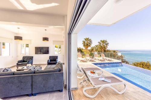 an open living room with a view of the ocean at Pomos Seashore villa in Pomos
