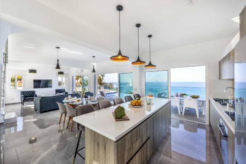 a kitchen and living room with a view of the ocean at Pomos Seashore villa in Pomos