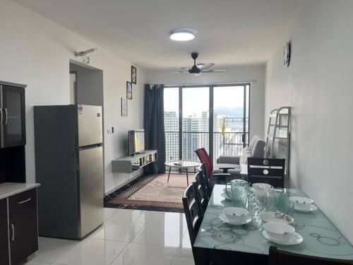 a kitchen and dining room with a table and a refrigerator at Cozy kenwingston Platz KL 2-5 pax 2BR&2BR genting view parkin netflix 3802 in Kuala Lumpur