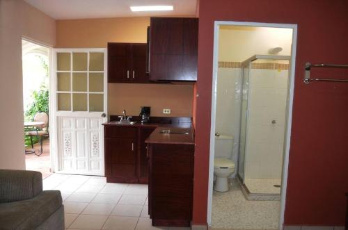 a kitchen with a sink and a toilet in a room at Hotel Boutique Los Arcos in Los Mochis