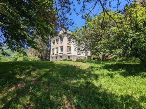 an old house on a grassy field with trees at Chambre Jonquille avec entrée privée et animaux admis - FR-1-589-718 in Sapois