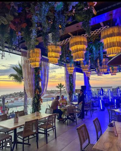 a restaurant with tables and chairs and chandeliers at Luxury, Ocean View, Pool, Jacuzzi, Valle de Guadalupe, Los Portales De Garcia, Splash, Encanto Restaurants, Surf Breaks in Primo Tapia, Rosarito in Rosarito