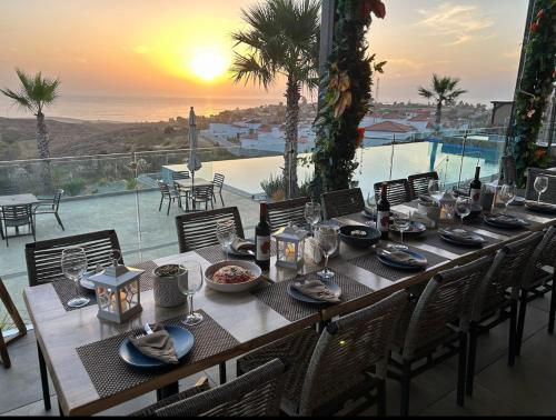 a dining table with a view of the ocean at Luxury, Ocean View, Pool, Jacuzzi, Valle de Guadalupe, Los Portales De Garcia, Splash, Encanto Restaurants, Surf Breaks in Primo Tapia, Rosarito in Rosarito
