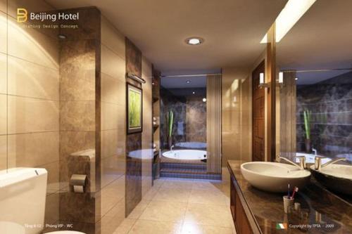a bathroom with two sinks and a tub and a toilet at Beijing Hotel Vinh - by BAY LUXURY in Ngô Xa