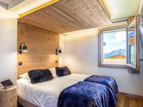 a bedroom with two beds and a window at Appartement 4 pièces aux Saisies avec SPA, parking, accessible PMR - FR-1-810-4 in Les Saisies