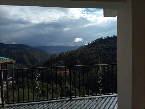 a balcony with a view of a mountain at Thakur homes- couple and family friendly homestay in Shimla