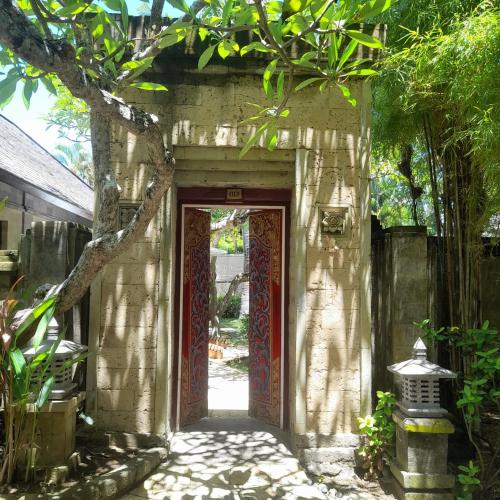 an entrance to a stone building with a red door at The Royal Beach Seminyak Bali in Seminyak