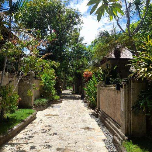 a path through the garden of a house at The Royal Beach Seminyak Bali in Seminyak