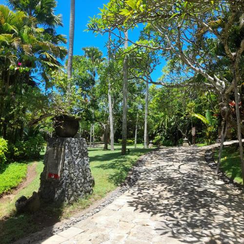 a path in a park with palm trees at The Royal Beach Seminyak Bali in Seminyak