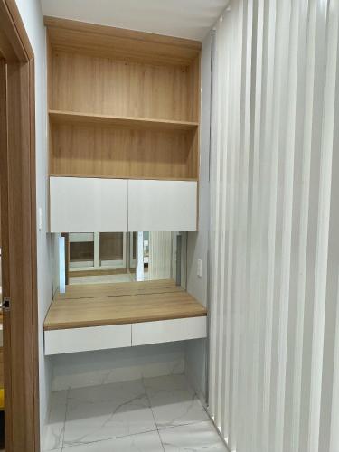 a room with a closet with wooden shelves at TPHomes Lakeview 122 in Ho Chi Minh City