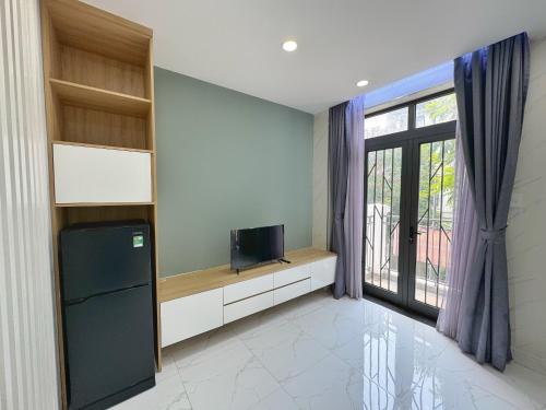 a living room with a tv and a window at TPHomes Lakeview 122 in Ho Chi Minh City