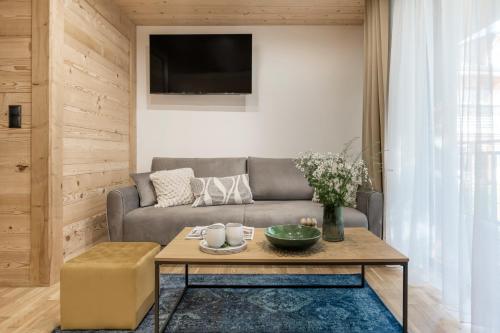 a living room with a couch and a table at Apres Ski Bachleda - LoftAffair Collection in Zakopane