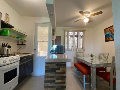 a kitchen with a stove and a table in it at LA CASABONITA vistalberca AirA in Alpuyeca