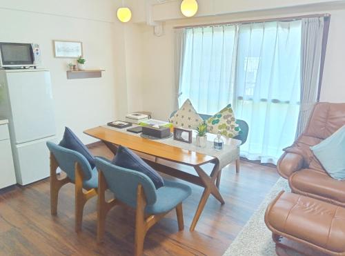 a living room with a table and chairs at Maple Sumikawa #201 in Sapporo