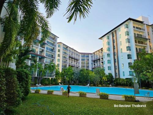 a large apartment complex with a swimming pool at AD resort ชะอำ in Ban Bo Khaem