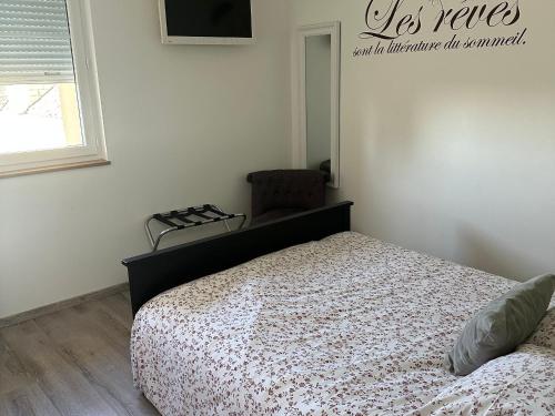 a bedroom with a bed and a window at Chambres avec petit déj inclus et table d'hôtes en Berry, près des Châteaux de la Loire - FR-1-591-700 in Fontguenand