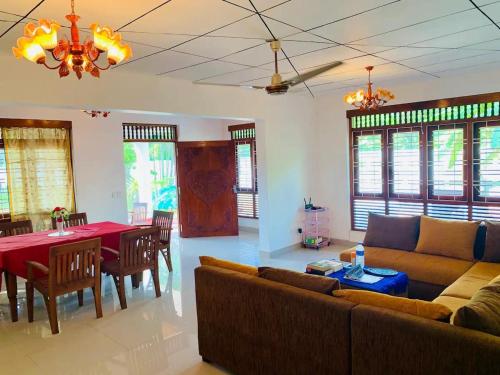 a living room with a couch and a table at Beach Star Villa Beruwala in Beruwala