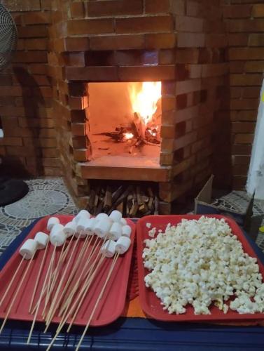 a plate of rice and chopsticks in front of a fireplace at Cabaña condominio los sauces in Moniquirá