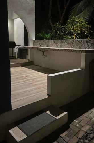 a view of a patio with a table and a bench at Tivives kikala Lodge in Esparza