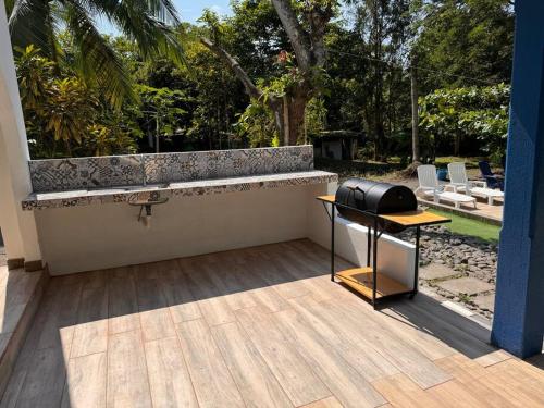 a black grill on a table on a patio at Tivives kikala Lodge in Esparza