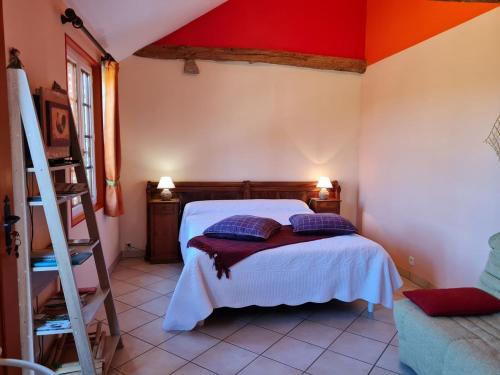a bedroom with a bed and a ladder in a room at Charmante suite Volière au RDC, parking privé - FR-1-590-470 in Bonnée