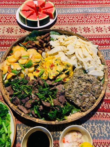 a table with a plate of food on a table at Du peak home in Làng Cac