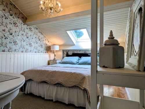 a bedroom with a bed and a chandelier at Chambre Verte avec Jardin partagé près du Puy-en-Velay - FR-1-582-498 in Rosières