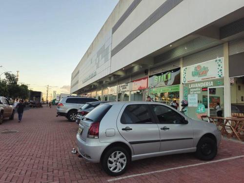 a silver car parked in front of a store at Apto Aconchegante e Confortável! in Uberaba