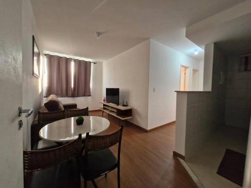 a living room with a table and a couch at Apto Aconchegante e Confortável! in Uberaba