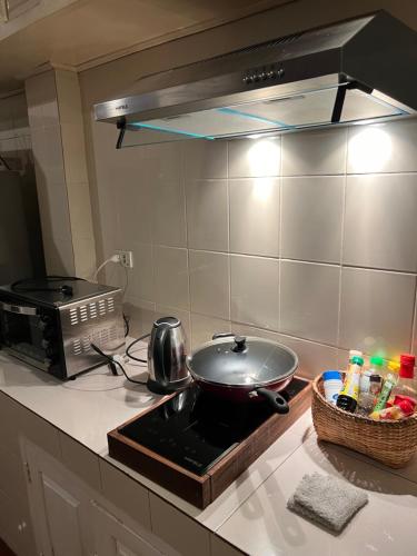 a frying pan on a stove in a kitchen at Xiengthong Villa in Luang Prabang