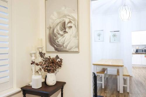 a living room with a table and a picture on the wall at Peters Rest Central Wagga in Wagga Wagga
