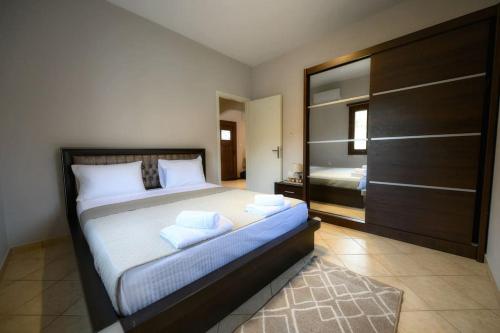 a bedroom with a large bed with two pillows at Serenity Haven in Kalymnos