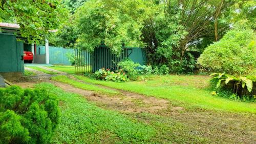 a yard with a dirt road next to a house at Madara Hotel in Horana