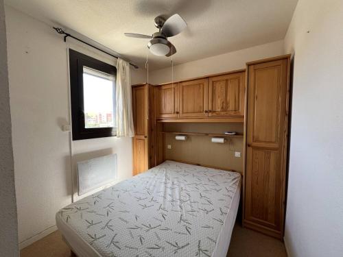 une petite chambre avec un lit et une fenêtre dans l'établissement Appartement T2 avec loggia, parking privé et proche plage, Port Leucate - FR-1-81-615, à Leucate