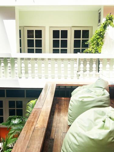 a room with a wooden bench and a balcony at Vonden Garden by Merry V in Bangkok