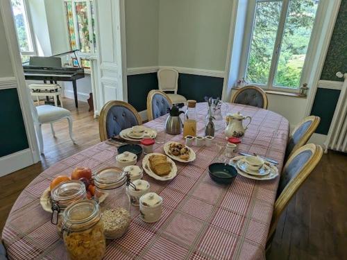 a dining room table with breakfast foods on it at Chambre Jonquille avec entrée privée et animaux admis - FR-1-589-718 in Sapois