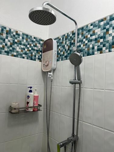a bathroom with a shower with a phone on the wall at Pani House ( Hatyai 2 ) in Hat Yai