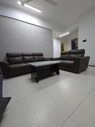 a living room with couches and a coffee table at Domus in Kota Kinabalu